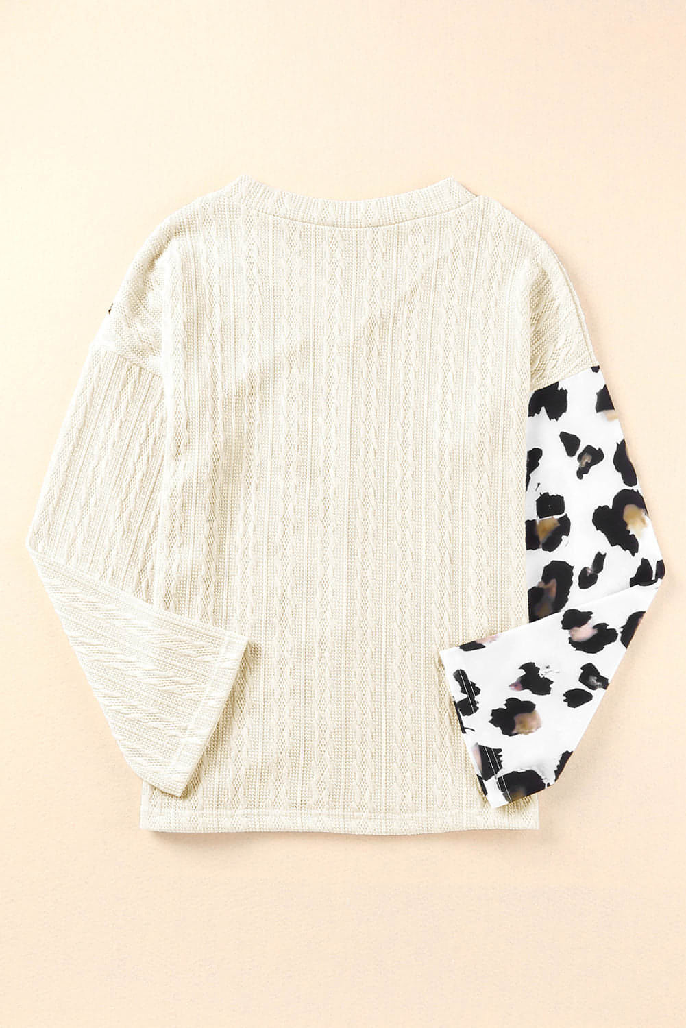 Beige asymmetric leopard patchwork wide sleeve V-neck sweater by Carmine Juneberry, featuring bold animal print and relaxed fit.