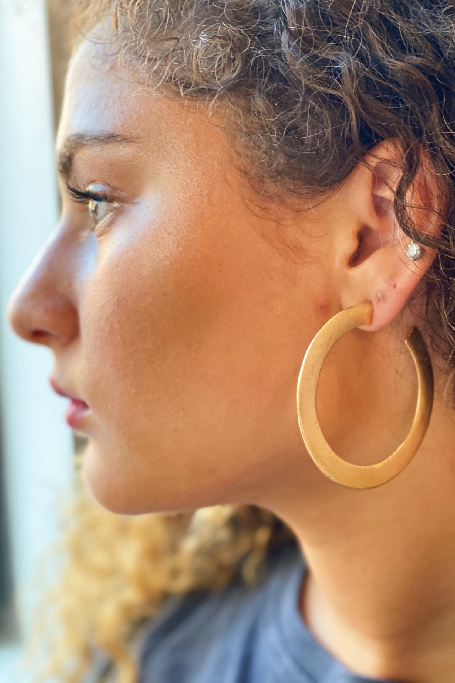 Fuchsia Hercules Alma Thick Flattened Gold Metal Hoop Earrings, jewelry and watches, close-up view of stylish gold hoop earrings.