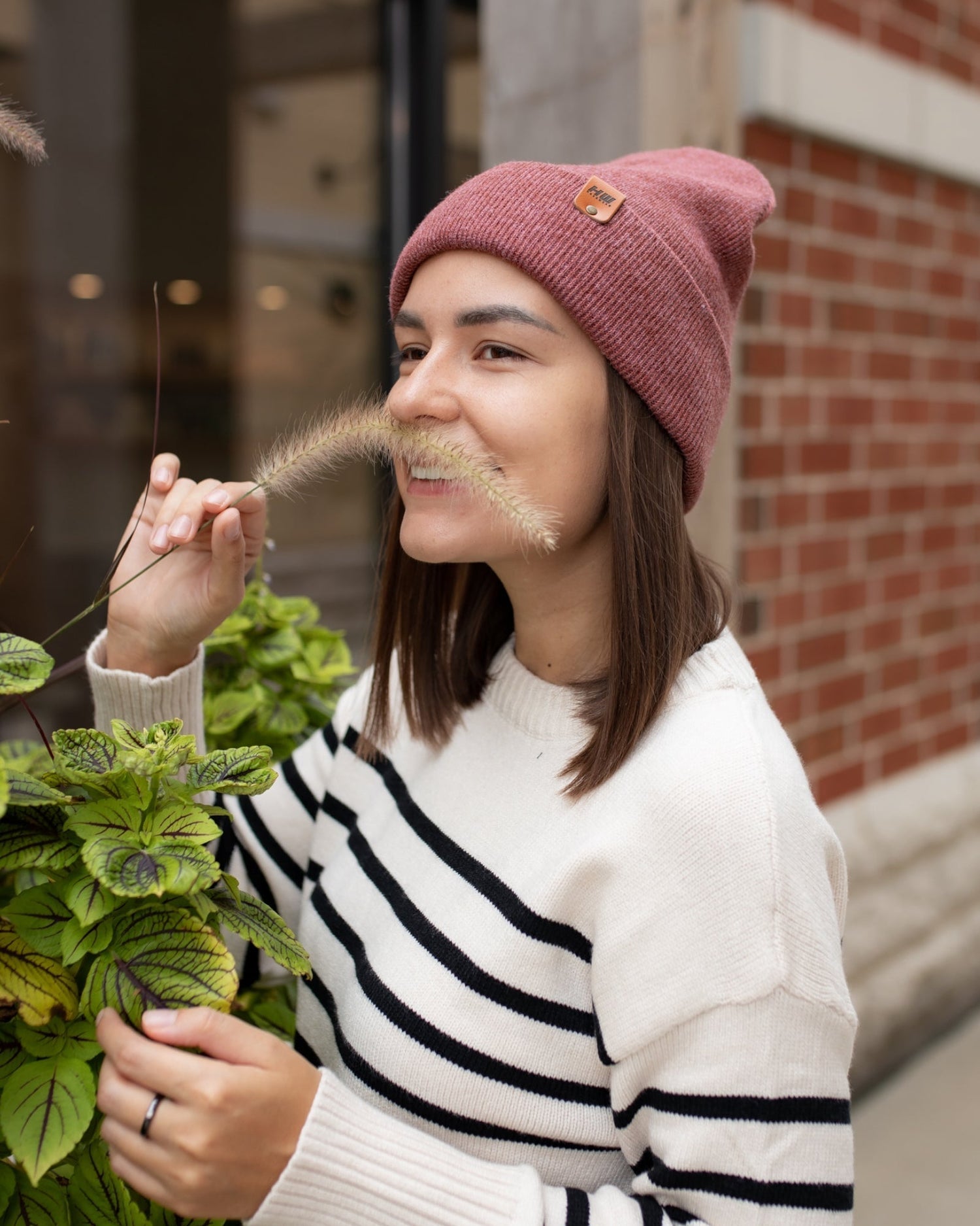 Azure Arrowwood HAAKWEAR knit cuffed beanie in rusty burgundy, showing the cozy, ribbed knit fabric and cuffed brim.