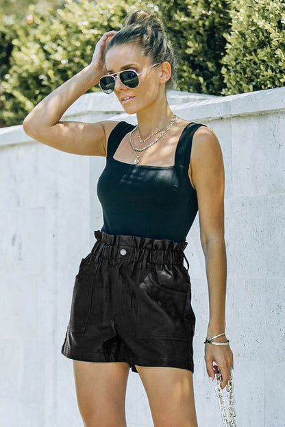 Black faux leather paper bag waist high-rise shorts by Carmine Juneberry, featuring a stylish paper bag waist design.