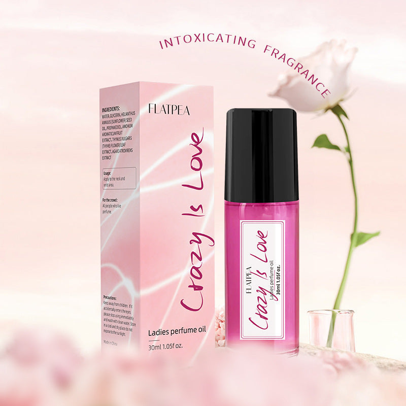 Carmine Juneberry Crazy In Love™ ball perfume oil for women, a luxurious bodycare product with a sleek container.