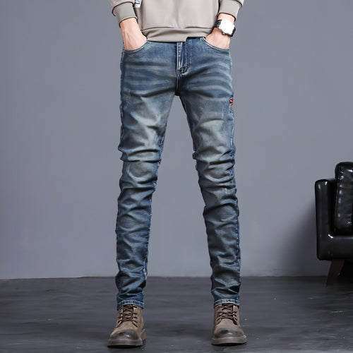 Youth retro embroidered denim pants for men by Carmine Juneberry, featuring classic blue jeans with vintage embroidery details.