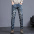 Youth retro embroidered denim pants for men by Carmine Juneberry, featuring classic blue jeans with vintage embroidery details.
