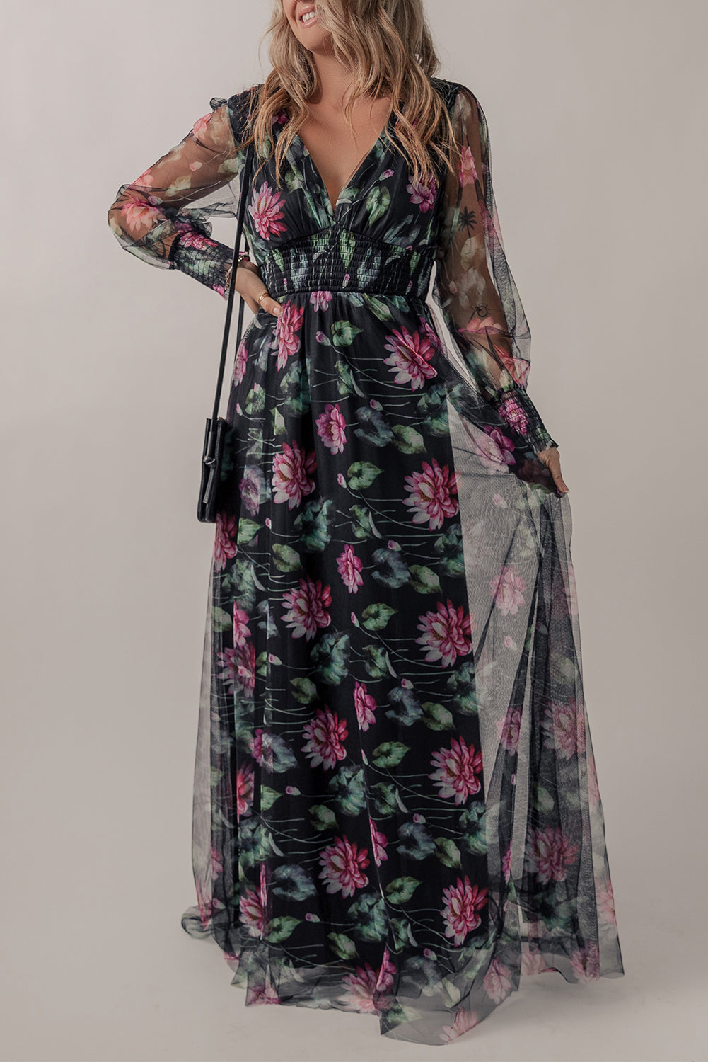 Black mesh sheer floral maxi dress with shirred high waist by Harlequin Daisy, featuring a flowing design and delicate floral pattern.