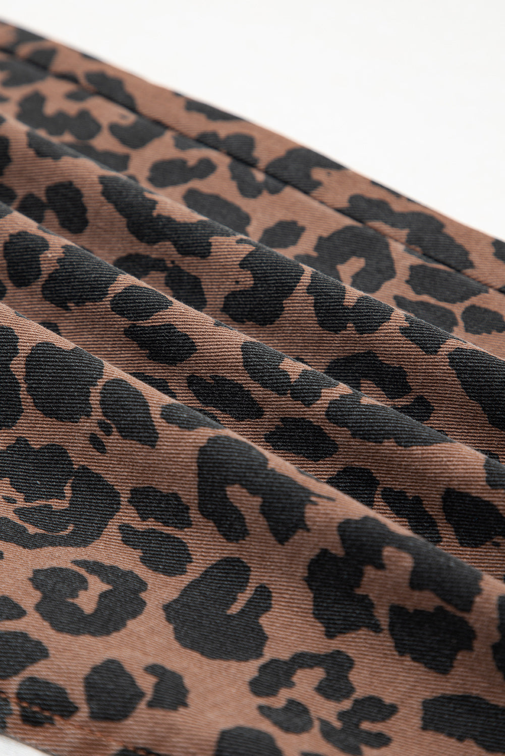 Leopard print denim midi skirt with frayed hem for women by Byzantium Bay, shown with a relaxed fit and stylish design.
