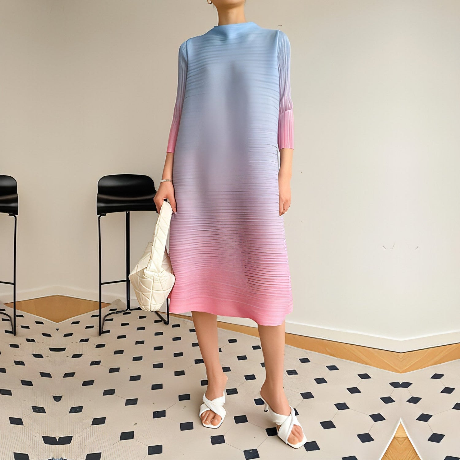 Plus size pleated dress for women by Carmine Juneberry, showcasing a flowy, stylish design with a fitted waist.