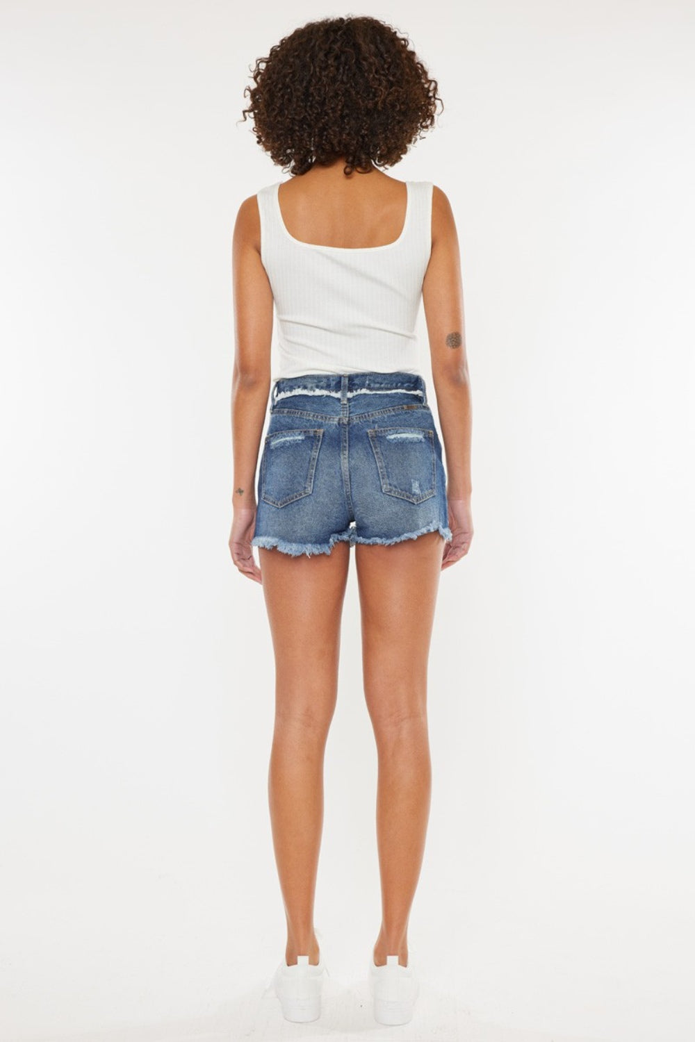 Jade Icarus Kancan distressed button fly denim shorts for women, showing frayed edges, distressed details, and classic denim fit.