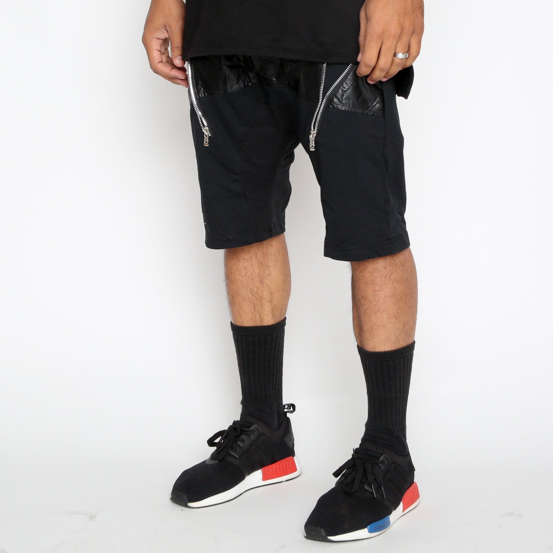 Leather front moto shorts by Lime Milo featuring a sleek design and zipper detailing on the front.