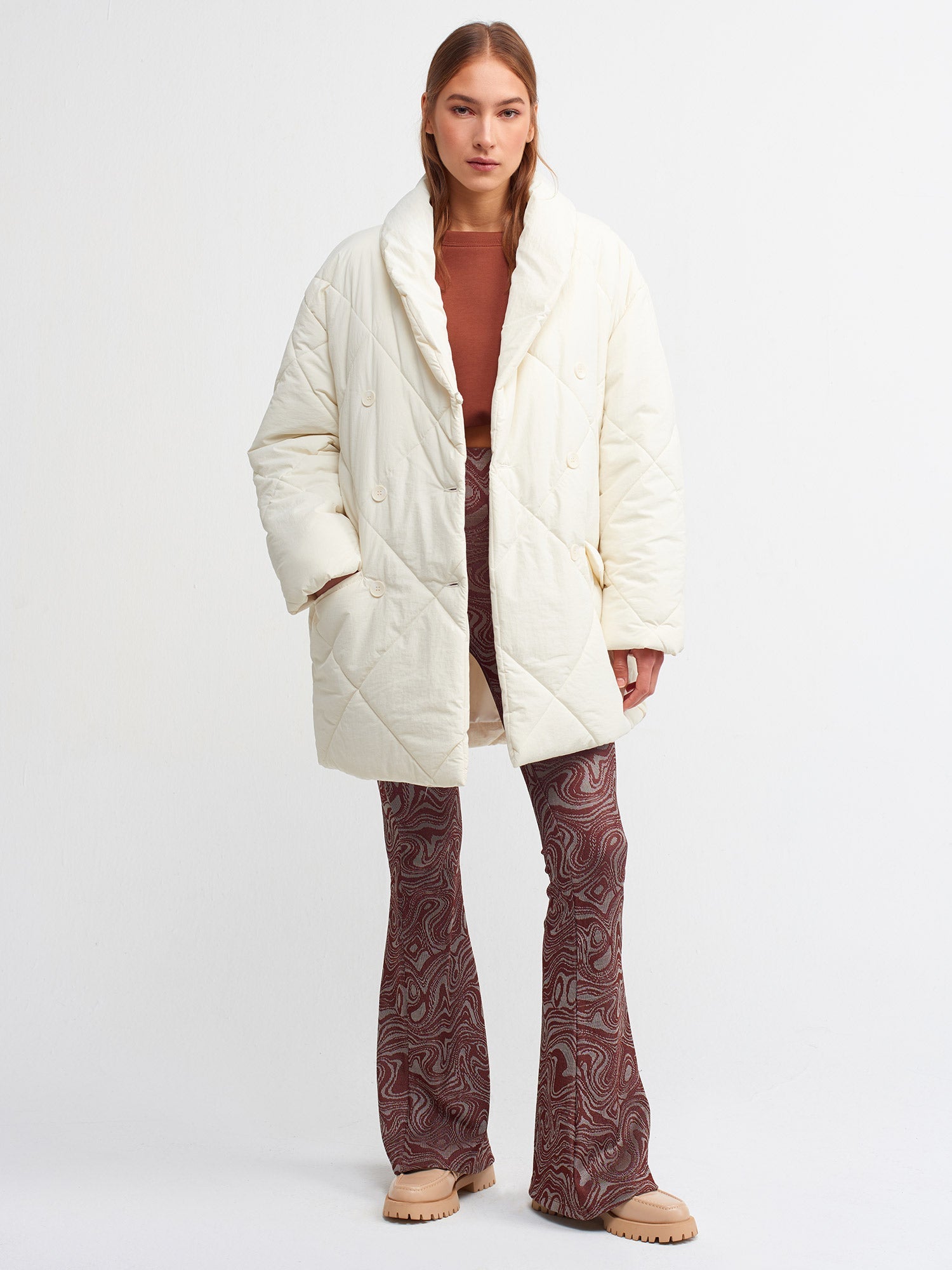 Women’s quilted coat by Ruby Dionysus in ekru color, featuring a cozy, padded design and stylish fit for cold weather.