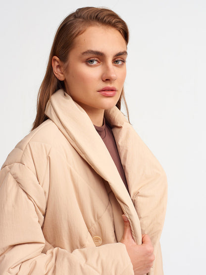 Beige quilted coat for women by Ruby Dionysus, featuring a stylish padded design and front zipper closure.