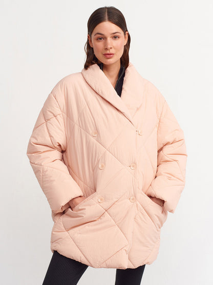 Pink quilted coat for women by Ruby Dionysus, showing a close-up of the padded, stylish outerwear with a high collar.