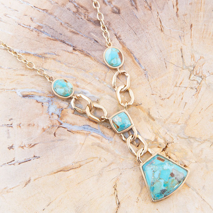 Athena Blue Turquoise and Gold Y Neck Necklace from Start2Finish, featuring vibrant turquoise stones and a elegant gold chain.