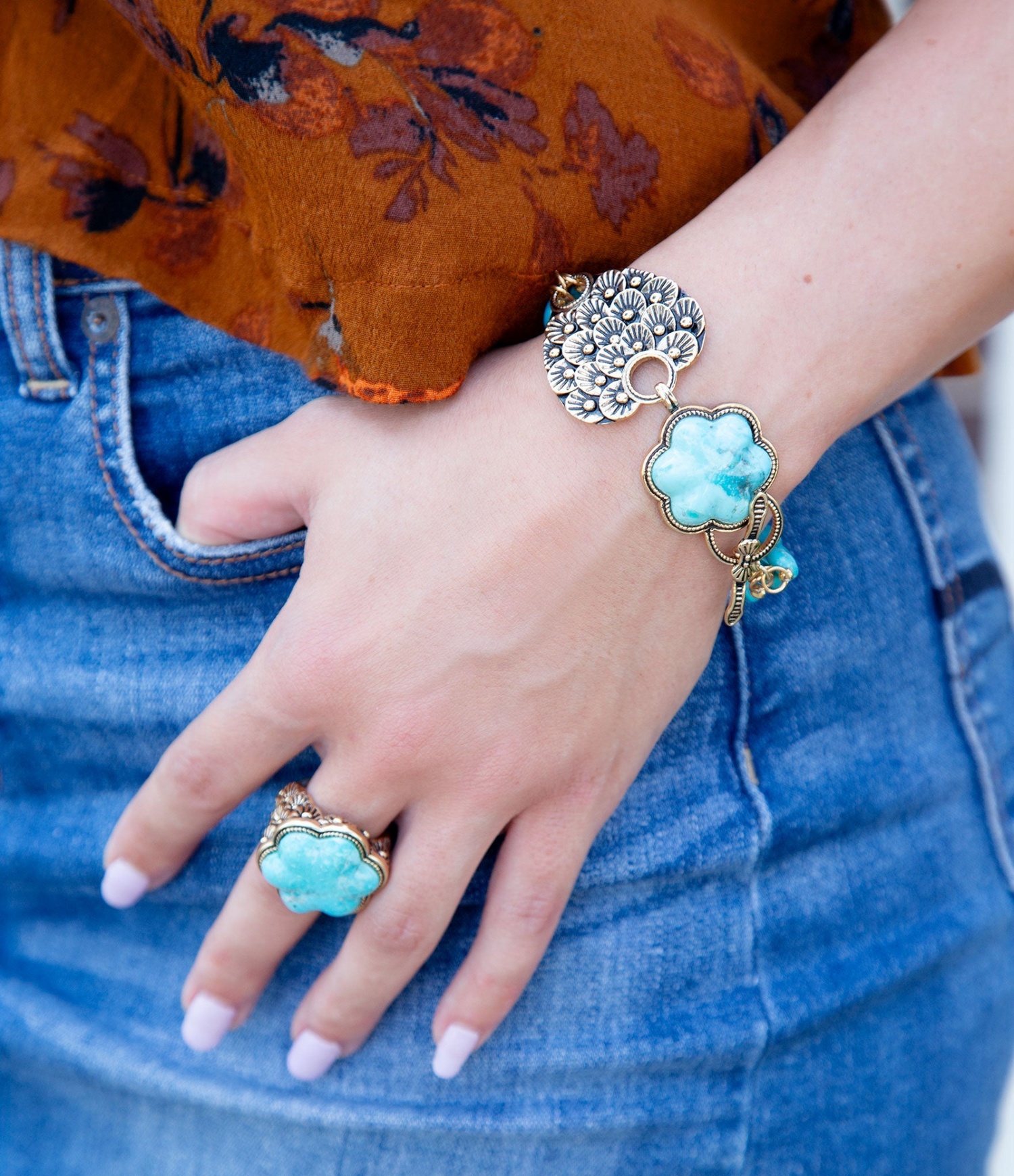 Blue turquoise flower gold ring from Start2Finish featuring a detailed floral design and shiny gold band.
