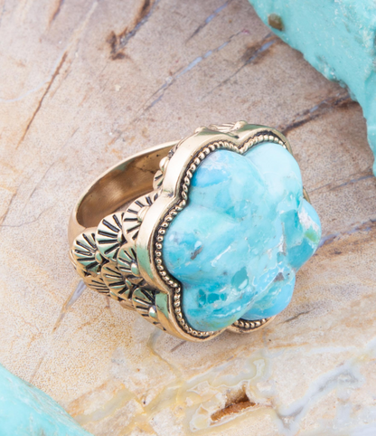 Blue turquoise flower gold ring featuring intricate jewelry design with a vibrant gemstone and delicate band.