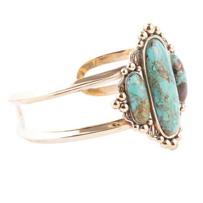 Blue turquoise and gold cuff bracelet from Start2Finish, featuring a wide, decorative jewelry piece with intricate details.
