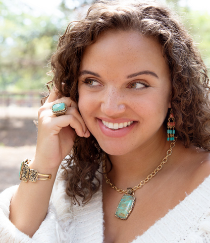 Start2Finish jewelry featuring a blue turquoise and golden cocktail ring with intricate design and polished finish.