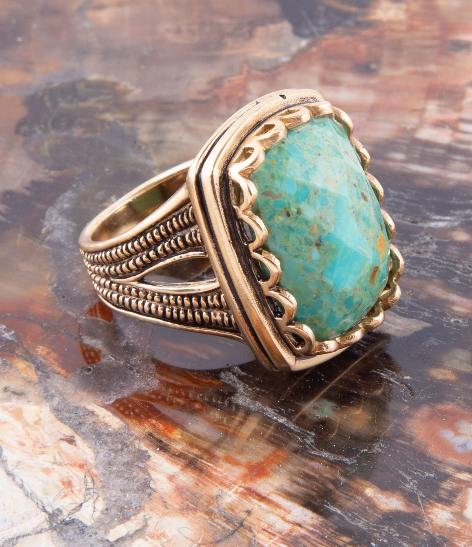 Blue turquoise and gold cocktail ring with intricate jewelry design, featuring a large central turquoise stone and golden accents.