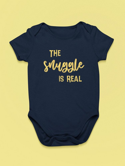 Baby bodysuit with "The Snuggle Is Real" quote in SmartPrintsInk design, featuring short sleeves and soft fabric.
