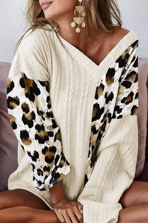 Beige asymmetric leopard patchwork wide sleeve V-neck sweater by Carmine Juneberry, featuring bold animal print and stylish design.