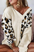 Beige asymmetric leopard patchwork wide sleeve V-neck sweater by Carmine Juneberry, featuring bold animal print and stylish design.