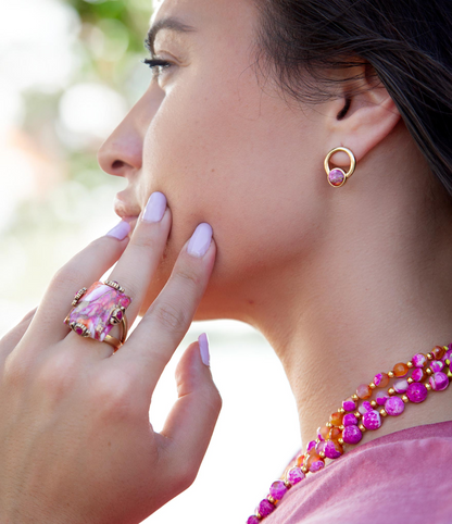 Prismatic pink spiny oyster matrix statement ring with intricate design, set in jewelry style, showcasing vibrant pink hues.