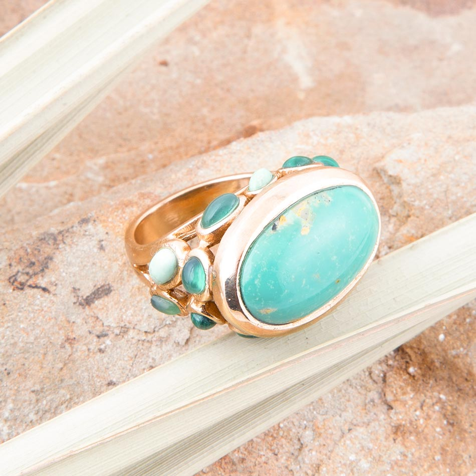 Start2Finish multi green stone gold statement ring showing a bold jewelry piece with green gemstones and a gold band.