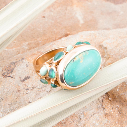 Start2Finish multi green stone gold statement ring showing a bold jewelry piece with green gemstones and a gold band.