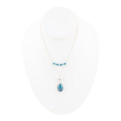 Layered blue apatite and sterling silver necklace featuring multiple blue gemstone beads and silver chain links.