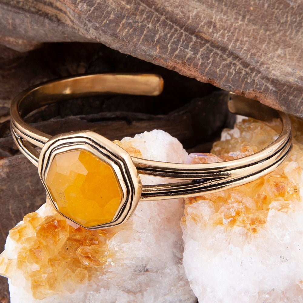 Yellow quartz river rocks and golden cuff bracelet from Start2Finish, showcasing a stylish jewelry piece with natural stone design.