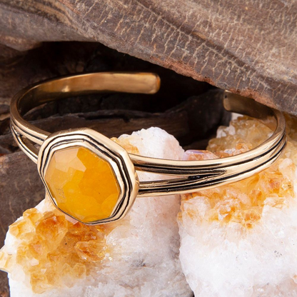 Yellow quartz river rocks and golden cuff bracelet from Start2Finish, showcasing a stylish jewelry piece with natural stone design.