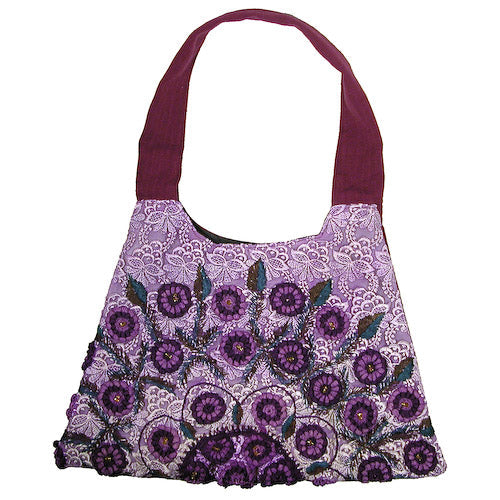 Recycled Rococo handbag with trapezoid shape by Erin Hercules, featuring colorful fair trade Guatemalan textile patterns.