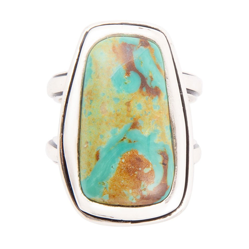 Art Blue turquoise and sterling silver statement ring, showcasing intricate jewelry design with vibrant blue stone and silver band.
