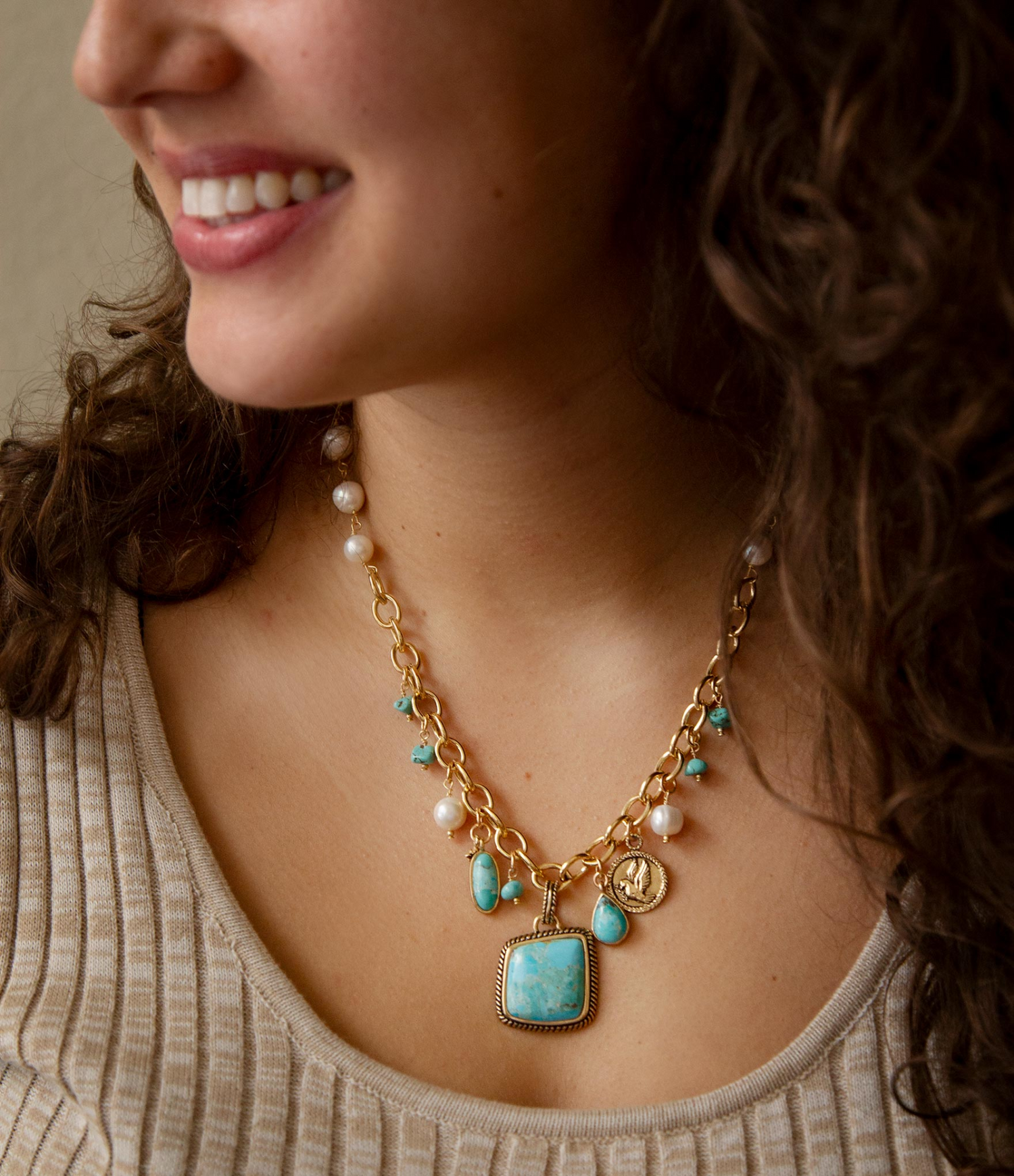 Blue turquoise, white pearl, and gold pendant necklace with multiple charms, stylish jewelry by Start2Finish.