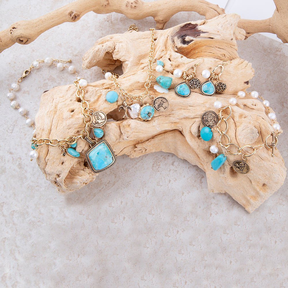 Blue turquoise and white pearl multi-pendant golden jewelry necklace with intricate design and chain detail.
