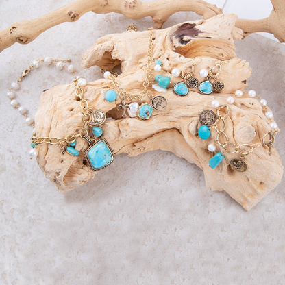 Blue turquoise and white pearl multi-pendant golden jewelry necklace with intricate design and chain detail.
