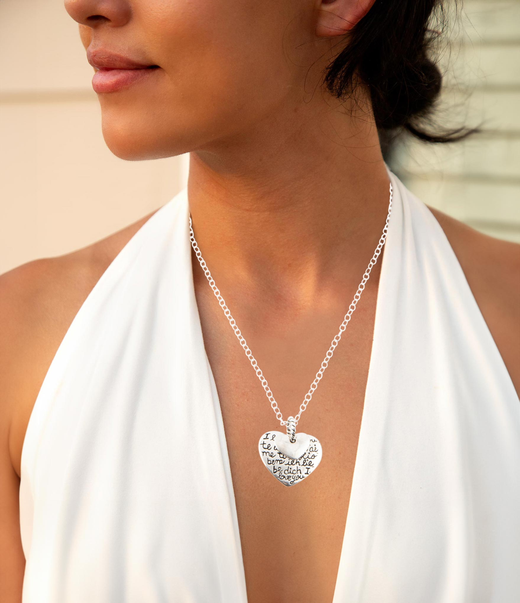 Sterling silver engraved heart pendant necklace with intricate design, jewelry piece showcasing a polished, romantic accessory.