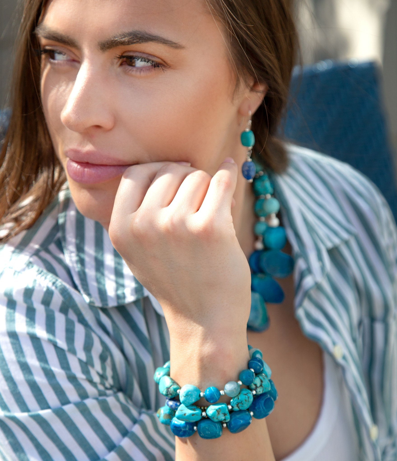 Sterling silver bracelet set with blue turquoise stones, featuring multiple bracelets with intricate designs and vibrant gemstone accents.