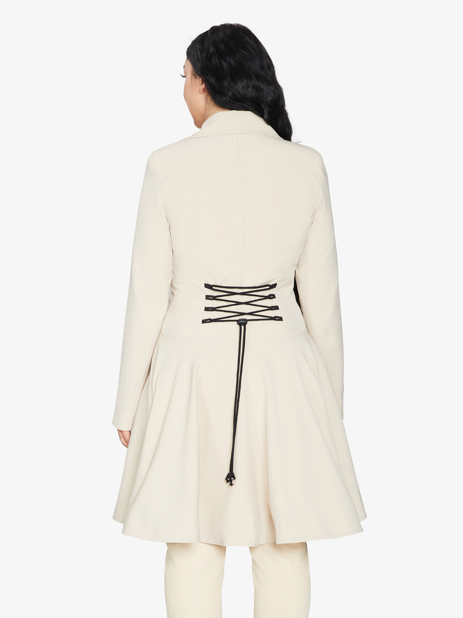 Rose Eleusis double-breasted skater coat in light stone color, perfect for spring and summer, shown on a hanger.