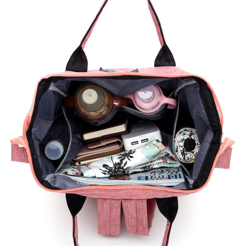 Carmine Juneberry AllFashion ActiveMom urban diaper backpack with anti-theft design, black fabric, multiple compartments, and adjustable straps.