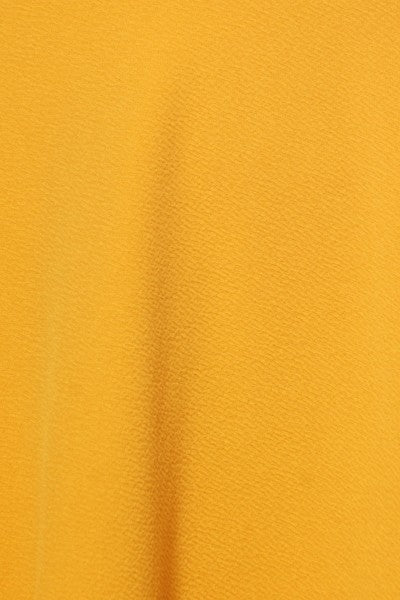 Solid high-waisted A-line knee-length skirt for women by Jade Icarus, shown in a natural pose highlighting its fit and fabric.