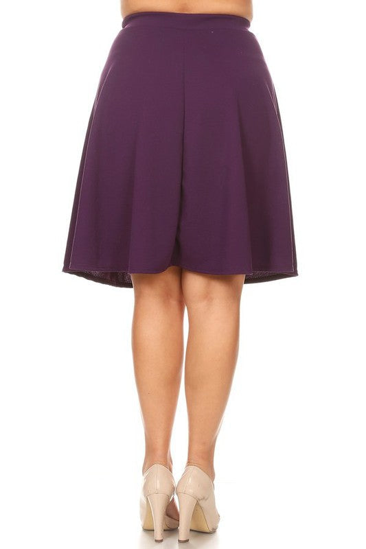 Solid high-waisted A-line knee-length skirt for women by Jade Icarus, shown in a natural stance on a plain background.