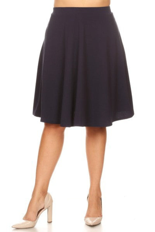 Solid high-waisted A-line knee-length skirt for women by Jade Icarus, shown in a natural pose on a neutral background.