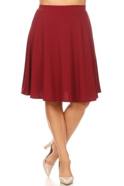 Solid high waisted A-line knee-length skirt for women by Jade Icarus, shown in a natural pose.