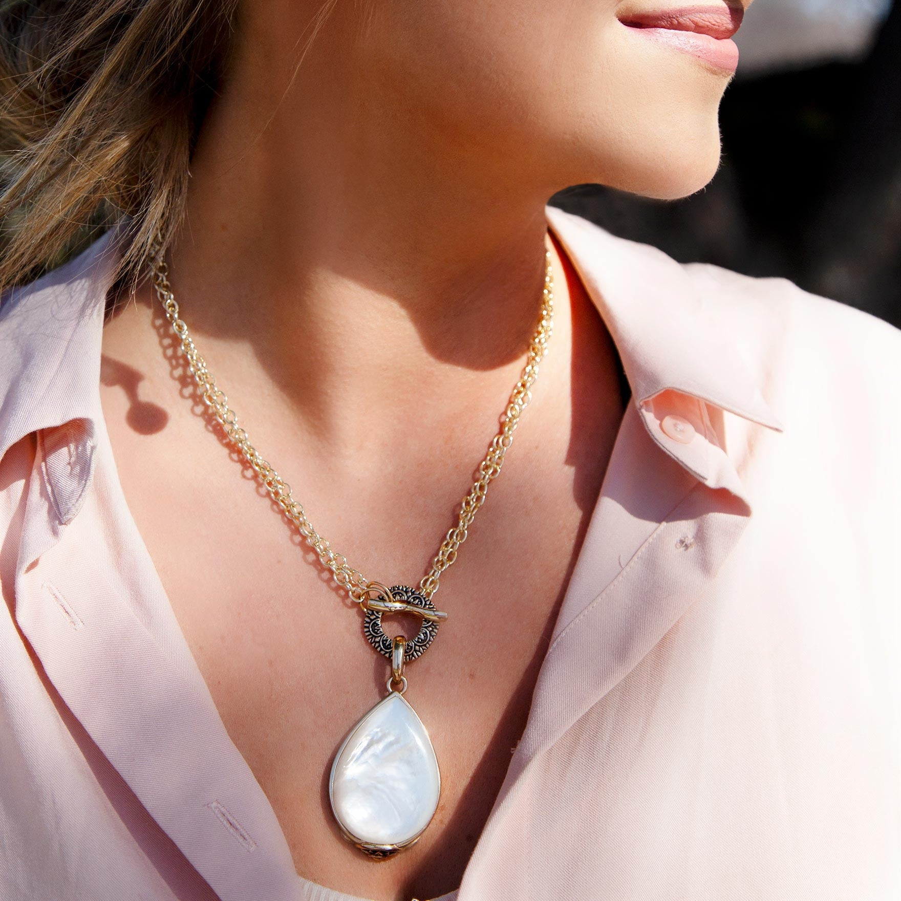 Start2Finish Abby white mother of pearl golden pendant necklace with intricate jewelry design, close-up view of pendant and chain.