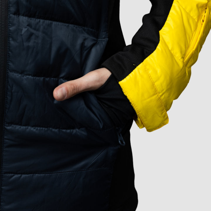 Yellow EcoDown activewear jacket for women by Rose Hemera, showing a lightweight, insulated outdoor jacket with a high collar.