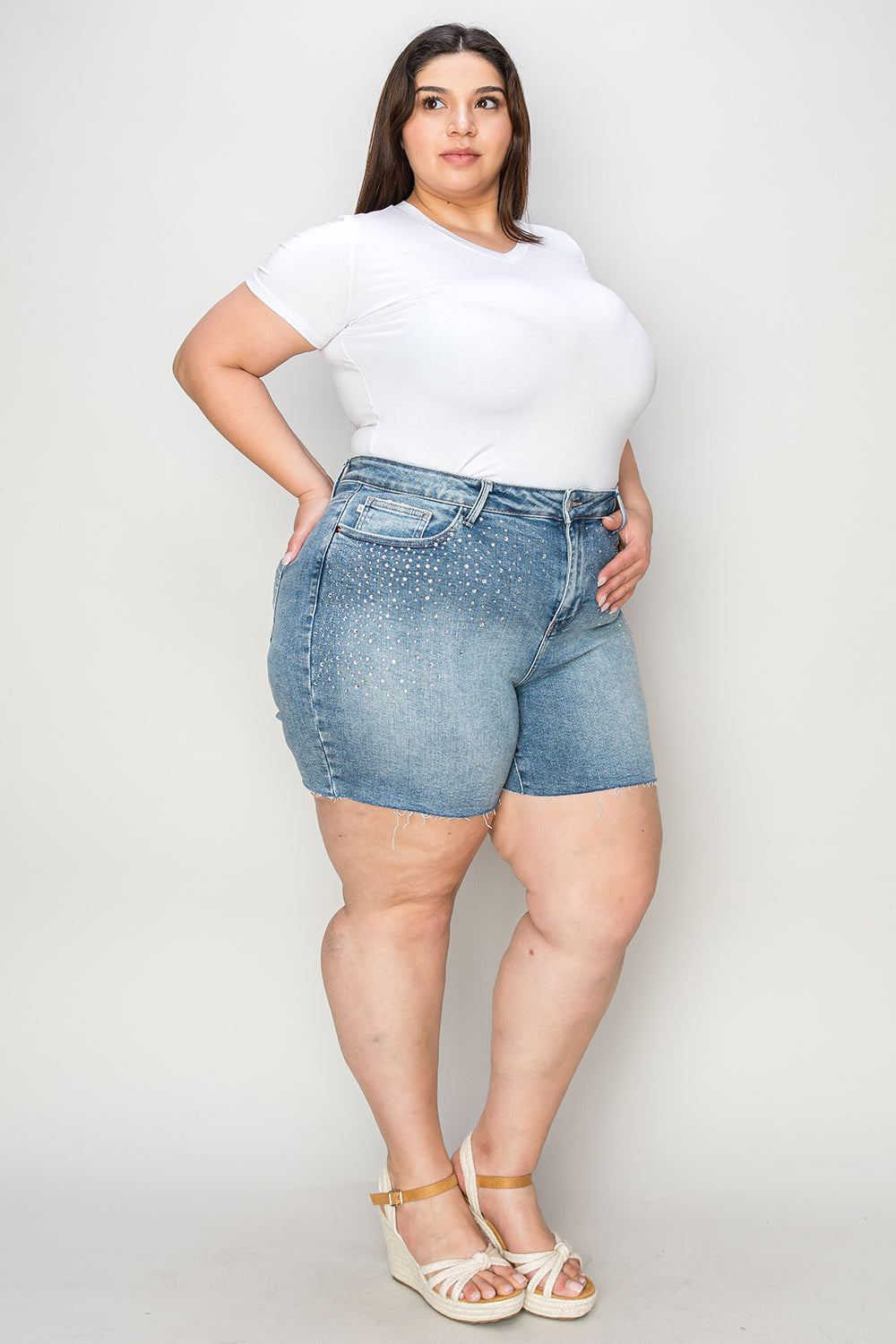 Judy Blue high waist raw hem denim shorts with distressed details, styled with a casual summer look.