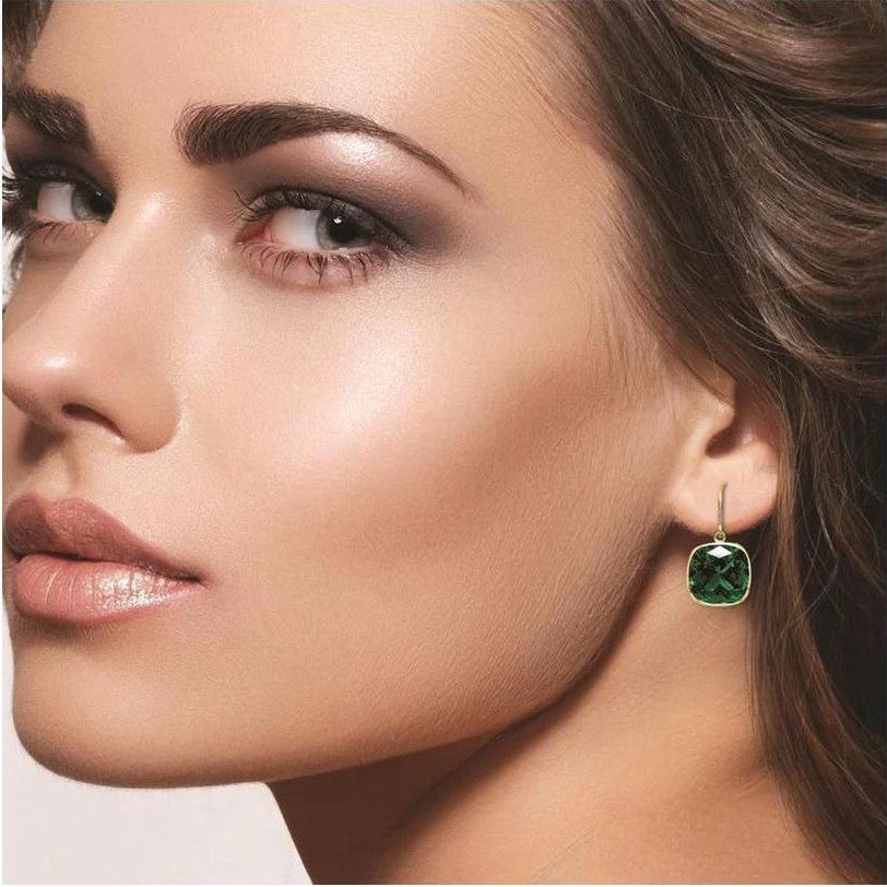 Two pairs of cushion cut blue sapphire and emerald drop earrings in sterling silver or 14k gold over silver, featuring 8mm square gemstones.