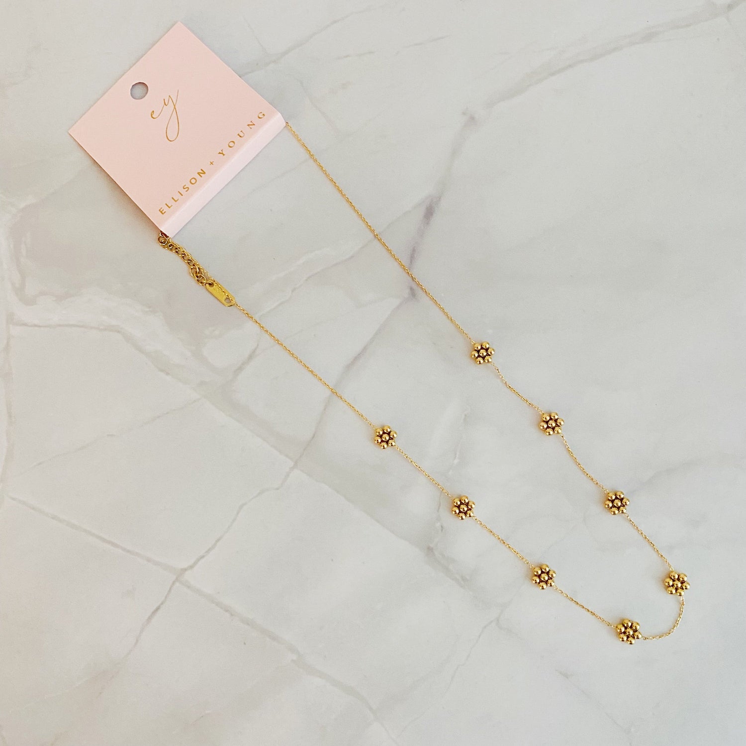 Dainty golden bead flower necklace by Fuchsia Hercules featuring waterproof stainless steel jewelry with floral design.