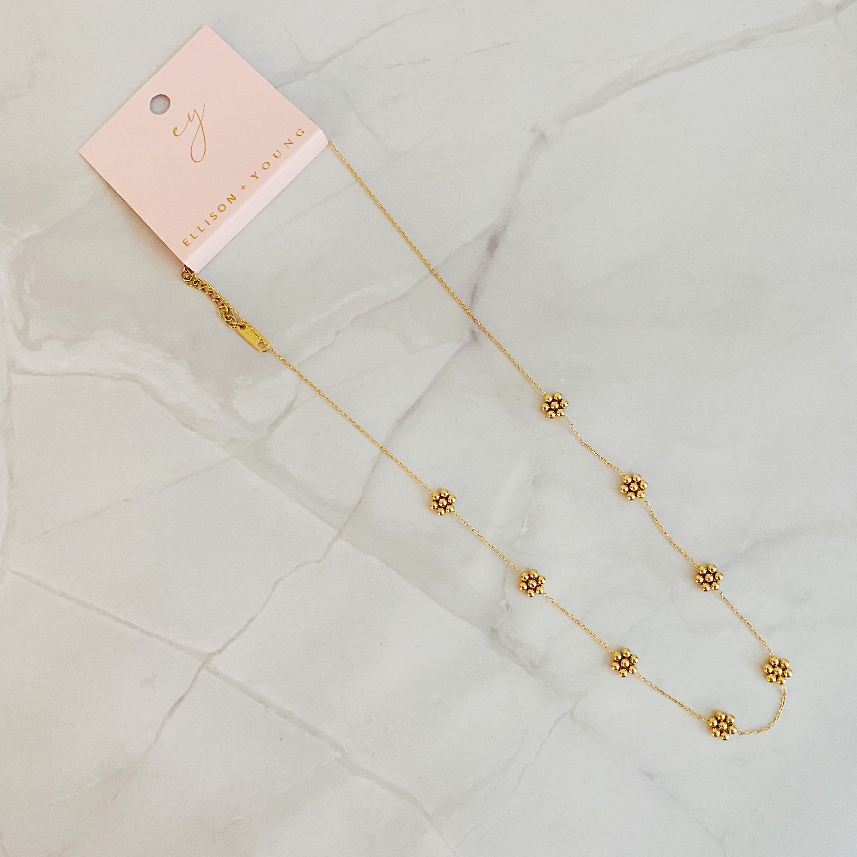 Dainty golden bead flower necklace by Fuchsia Hercules featuring waterproof stainless steel jewelry with floral design.