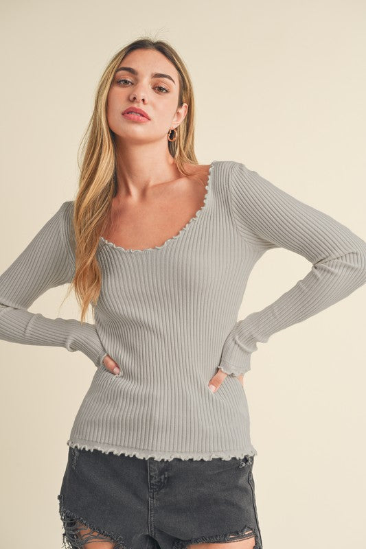 Automotive image showing a Jade Icarus Aemi + Co Lettuce Hem Scoop Neck Long Sleeve Knit Top with detailed lettuce hem and scoop neckline.